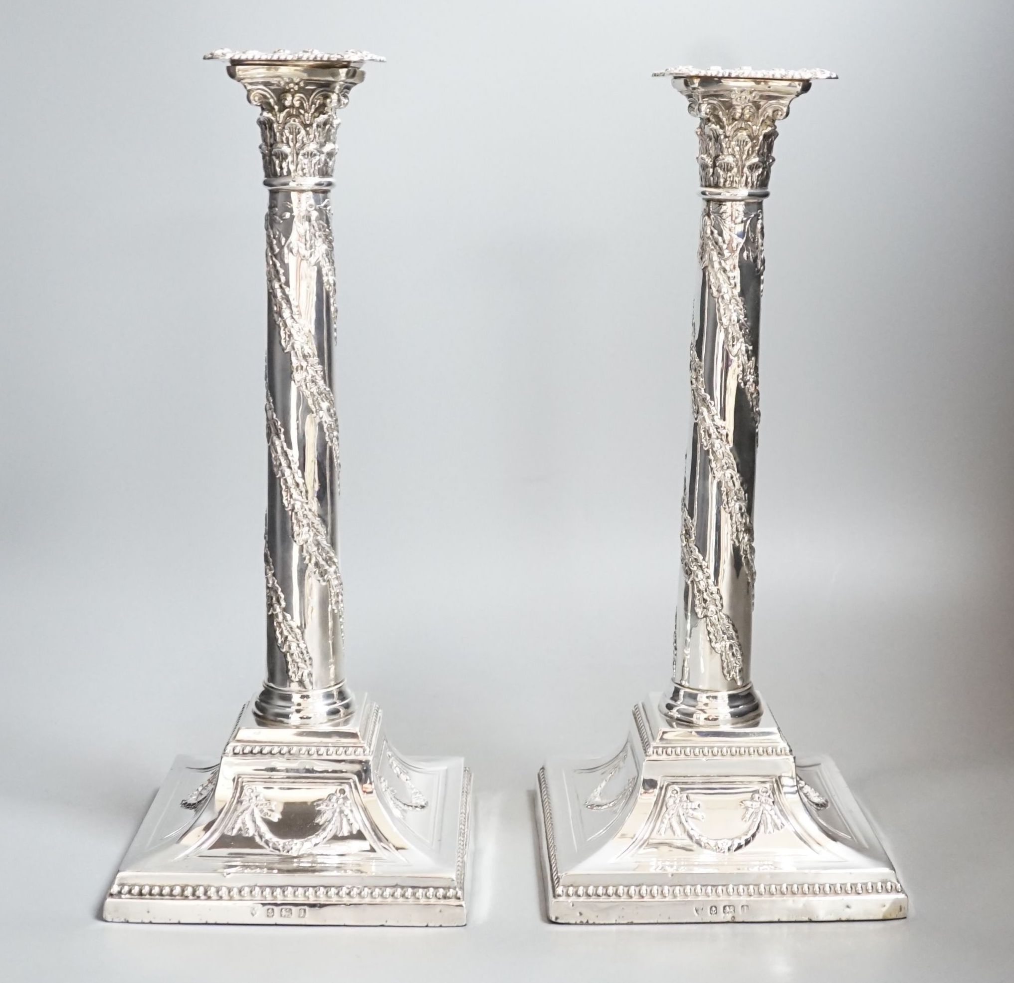 A pair of George V silver Corinthian column candlesticks, with spiral harebell columns, Ellis & Co, Birmingham, 1910, 34.2cm, weighted.